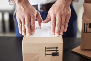 label-delivery-or-hands-of-man-with-box-for-couri-2025-04-06-10-19-52-utc